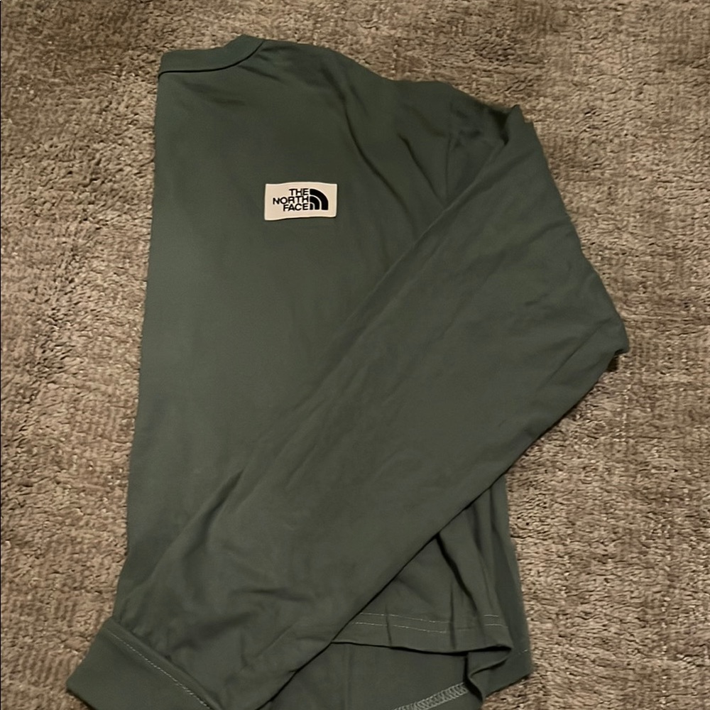 The North Face Green Long Sleeve Cropped Shirt.